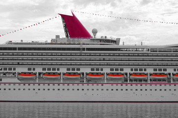 Modern cruise ship liner sideview or side with water and sky and clouds
