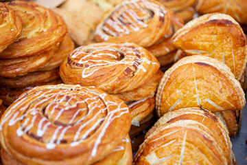 A closeup view of several varieties of french pastries on display at a local bakery.