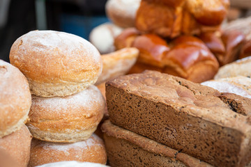 A closeup view of several bread and roll varieties on display at a local bakery.