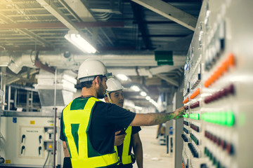 Two Electrical Engineer team working front control panel, Engineer training job with control panel...