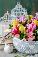 Woman shows how to make beautiful floral arrangement with tulip and carnation flowers