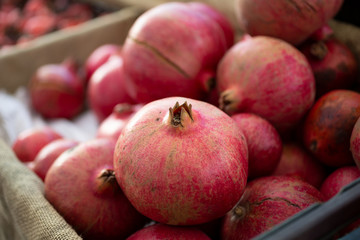 A closeup look at several pomegranate fruit on display at a local farmers market.
