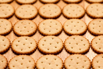 Background of round crackers on wooden table