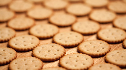 Round crackers on wood background. Shallow depth of field
