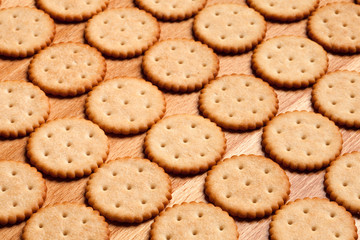 Round crackers on wood background.