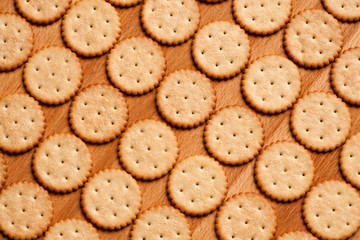 Round crackers on wood background. Top view