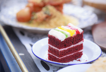 Fresh Homemade Delicious Multilayered Red Velvet Cake topped with colorful whipped cream, perfect for teatime. Food Catering, Healthy Dessert, Sweet, Treat, Restaurant, Cafe, Cooking and Hobby concept