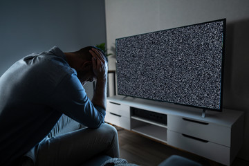 Man In Front Of Television With No Signal