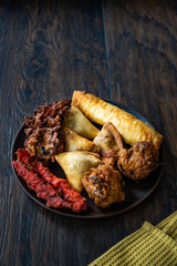 Indian Food Plate with Chicken Pakora, Aloo Tikki, Samosas Samsa and Spring Rolls.