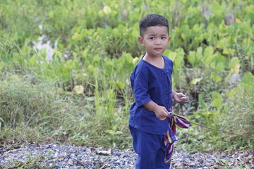 Happy baby child sitting on rural road, behind kid embrace life, dreamlike evening light, slow motion, innocent and pure love concept.                                                          