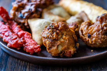 Rava Bhajj or bhajiya also known as suji Pakoda or semolina Pakora with Indian Asian Food Samosas /...
