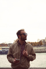 Handsome man using cellphone while enjoying in Paris.