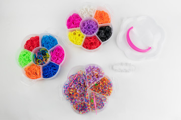 colored rubber bands for weaving are in the box. children's game On a white background. Close-up