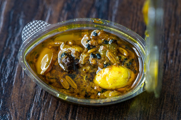 Indian Food Sauce with Garlic, Cardamom, Currants and Various Spices in Plastic Box Package / Container.