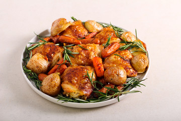 Roast chicken thighs with potatoes, carrot and rosemary