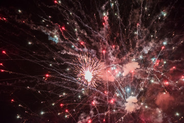 Fototapeta na wymiar Celebratory colorful fireworks light up the night sky. closeup. New year