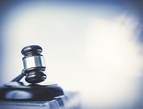 Law concept image, gavel set against bright computer monitor screen background