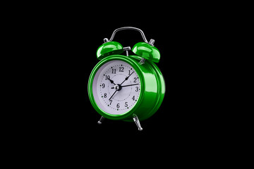 Green alarm clock close-up isolated on dark background.