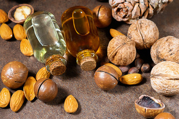 bottle of aroma oil, nuts, almonds, walnuts, macadamia. organic cosmetic products, selective focus....