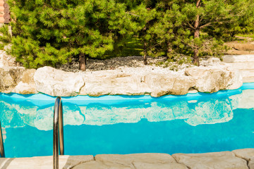 blue water in the pool in the courtyard background landscaping of the courtyard