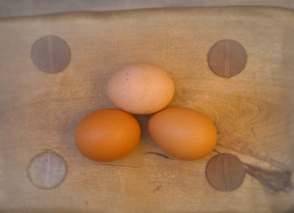 three eggs on a wooden table