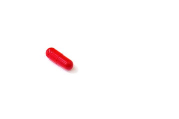 Red pill on a white background close-up.Copy space.