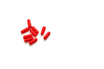 Red pills on a white background close-up.Copy space.