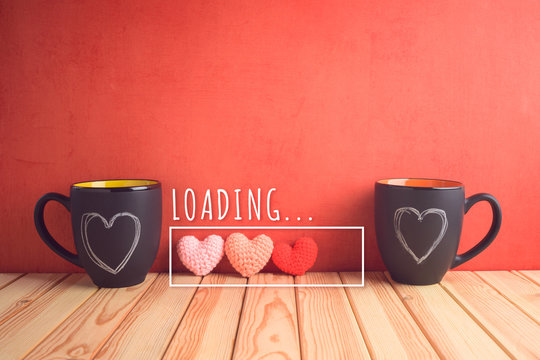 Valentines Day Concept With Chalkboard Coffee Mugs, Heart Shapes And  Loading Love Text On Wooden Table.