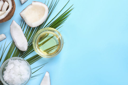Flat lay composition with coconut oil on light blue background, space for text