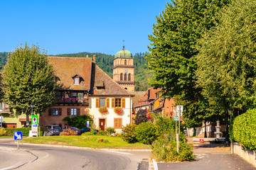 Fototapeta na wymiar ALSACE WINE REGION, FRANCE - SEP 20, 2019: Street with typical houses in Kaysersberg picturesque village which is located on Alsatian Wine Route, France.