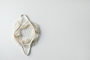 Empty net bag on white background, top view. Space for text