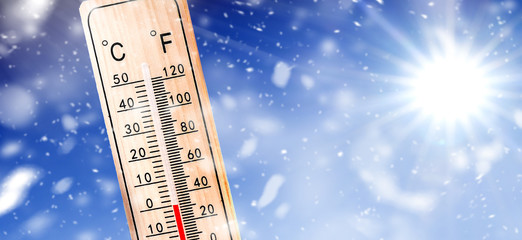 Thermometer in winter on snow shows low temperature in celsius or farenheit. Thermometers at snowing time.