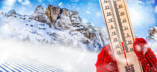 Thermometer in winter on snow shows low temperature in celsius or farenheit. Thermometers at snowing time.