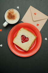 Composition for valentines day card with coffee, enveloope and sandwich heart shaped