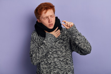 young weak man going to eat capsule, he suffers from terrible flu. close up portrait