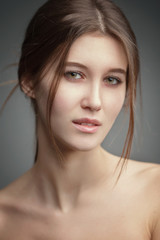 Naklejka premium An expressive gentle portrait of a young attractive girl with wet hair.
