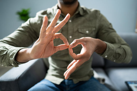 Man Using Sign Language To Communicate Against