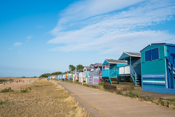 Colourful wooden beach huts facing the ocean at Whitstable coast,  Kent district England.