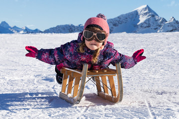 Kid Sliding With Sledge In The Snow