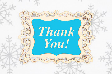 Thank you message in a wood frame with snowflakes
