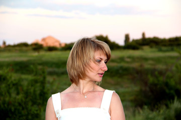 Fototapeta na wymiar Girl on the background of a green field