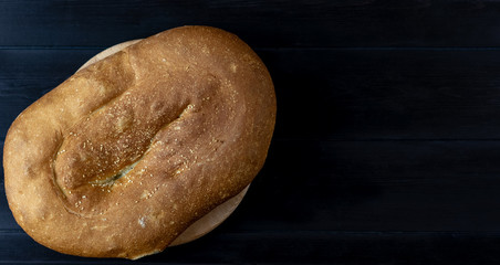 Fresh bread on a wooden background