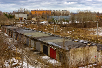 Fototapeta na wymiar Old car garages in industrial area of city in spring