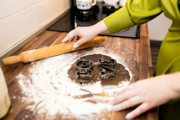 A young housewife makes cookies to celebrate.Close up