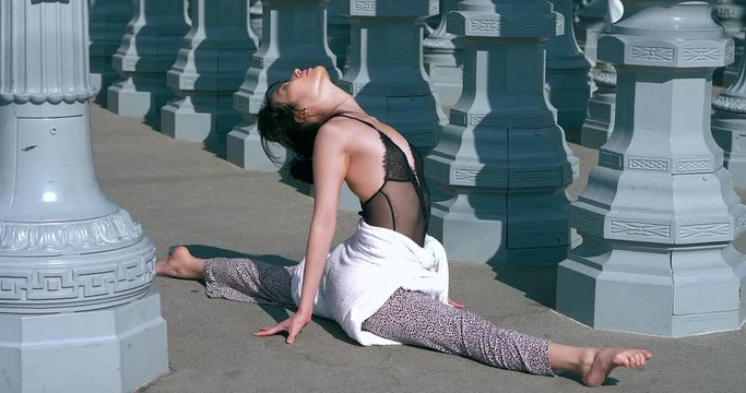 Young japanese fitness gymnast yoga flow girl performs stretching exercise in Los Angeles, California, 4K