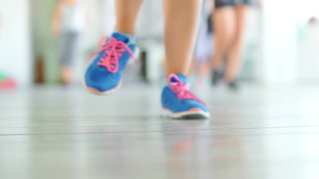 Dance fitness zumba class group of beautiful women dancing enjoying workout practicing choreography moves with instructor in fitness studio, 4k slow motion