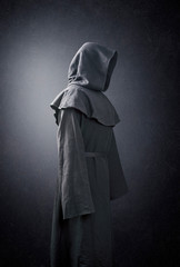 Scary figure in hooded cloak - obrazy, fototapety, plakaty