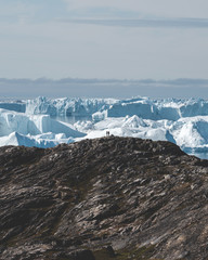 Arctic nature landscape with icebergs in Greenland icefjord with midnight sun sunset sunrise in the...
