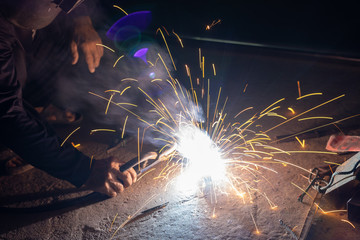 The welder is welding the various parts of the house construction.