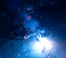 The welder is welding the various parts of the house construction.